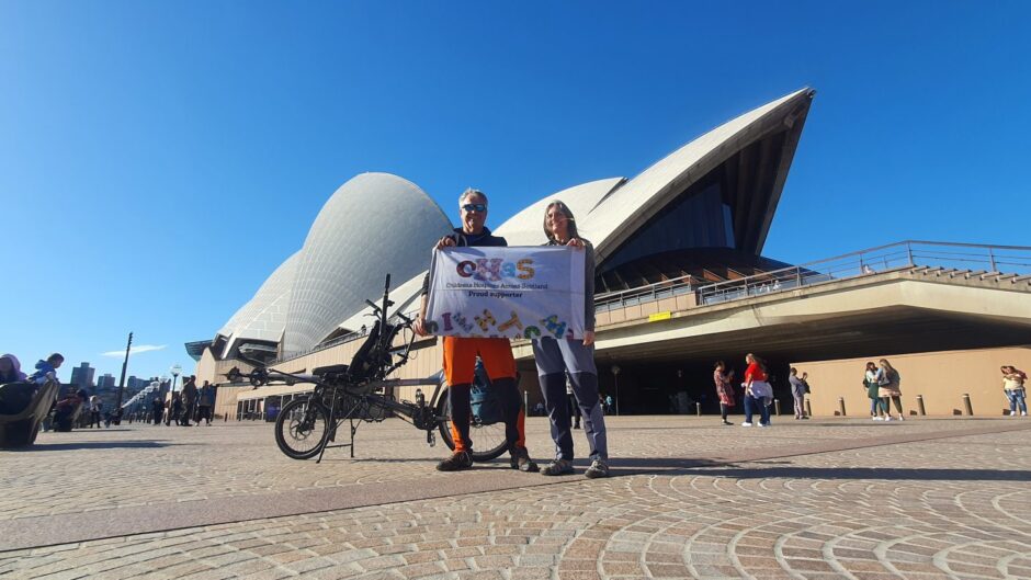 Bob and Deborah Gulliver with a CHAS banner outside the Sydney Opera House.