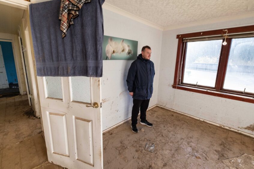 Euan Clark in his flat on River Street, Brechin, in the aftermath of the flooding.