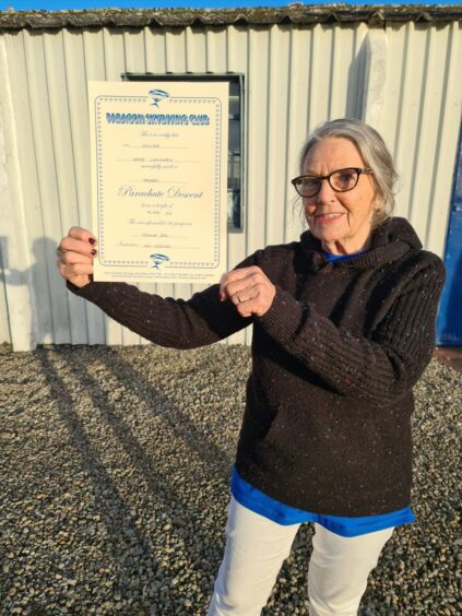 Irene Cattanach holding skydiving certificate
