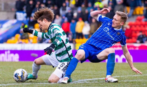 Celtic's Kyogo Furuhashi and St Johnstone's Matt Smith in action.