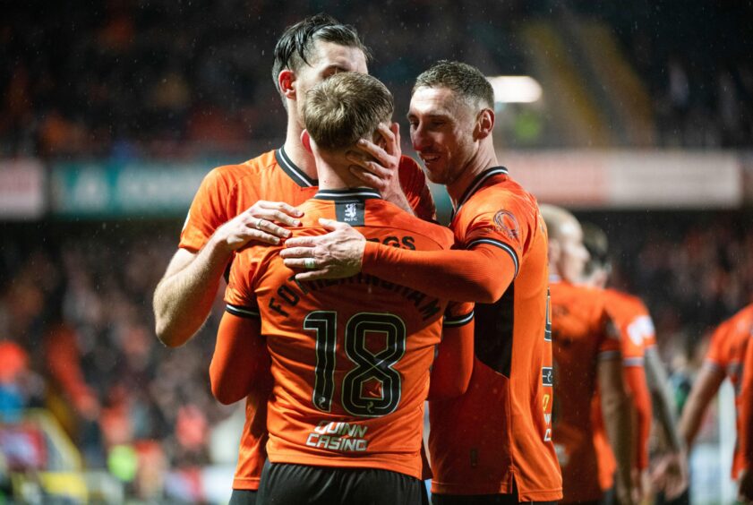 Kai Fotheringham of Dundee United is congratulated by his teammates