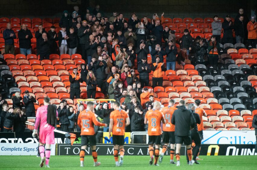 Dundee United players take the applause of the supporters