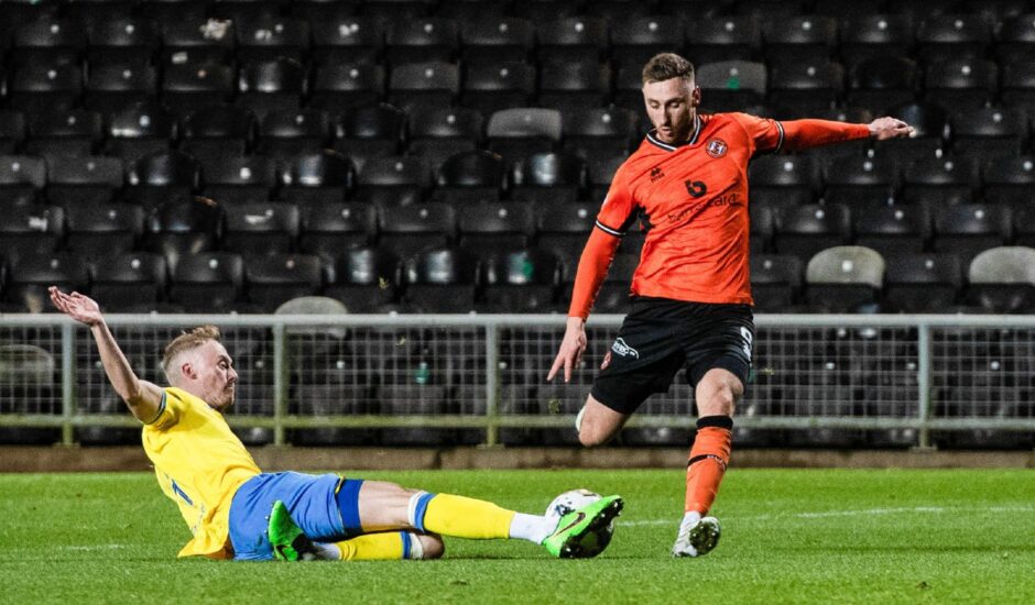 Raith Rovers' ROss Millen makes a wonderful challenge to deny Louis Moult of Dundee United