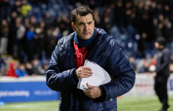 Manager Ian Murray clutches his notes at a Raith Rovers game.