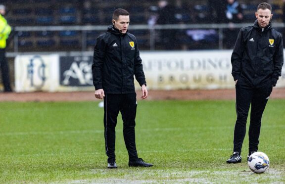 Referee David Munro conducts a pitch inspection before a cinch Premiership match before calling off the Dundee v Aberdeen match. Image: SNS