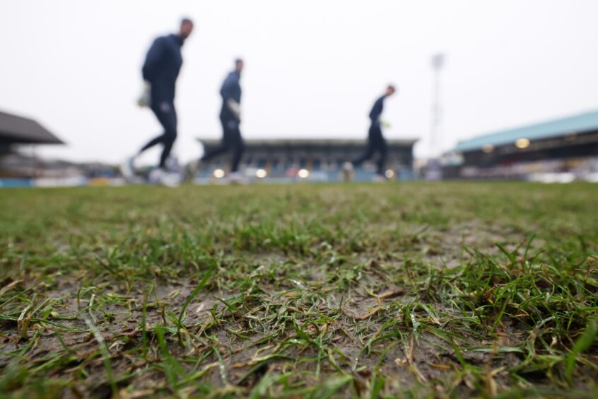 Dundee players train on the Dens Park pitch after the Aberdeen game was called off. Image: SNS