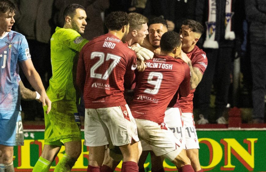 Jay Bird and Jermaine Hylton are separated by Arbroath team-mates. Image: SNS.