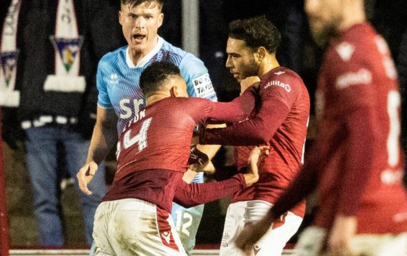 Arbroath team-mates Jermaine Hylton (left) and Jay Bird clash during the meeting with Dunfermline Athletic on December 23. Image: Mark Scates / SNS Group.