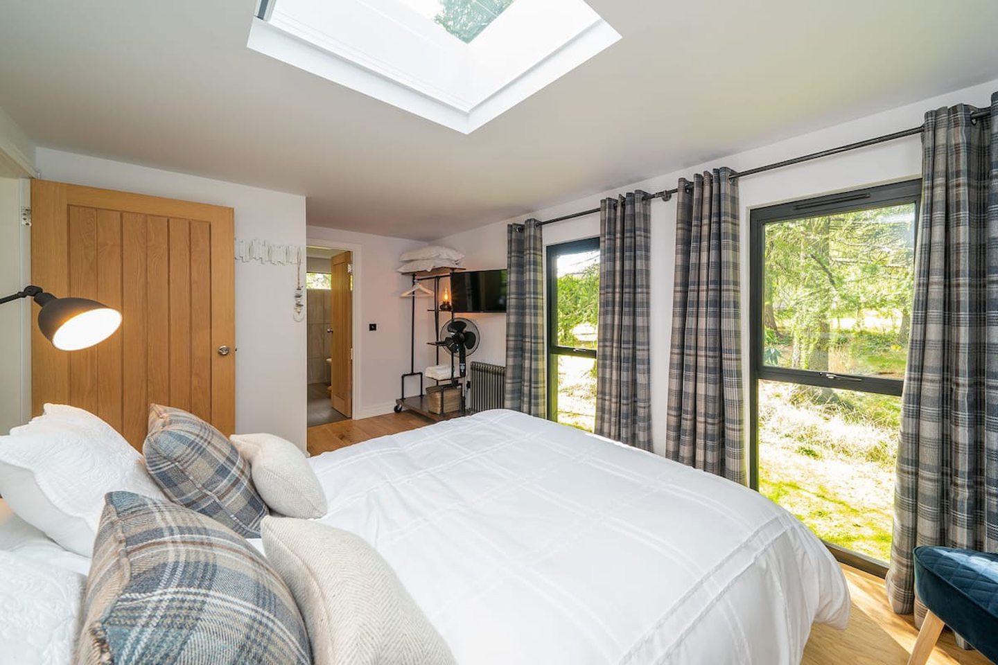 One of the bedrooms in Rowanbank Cabin featuring a skylight and large windows.