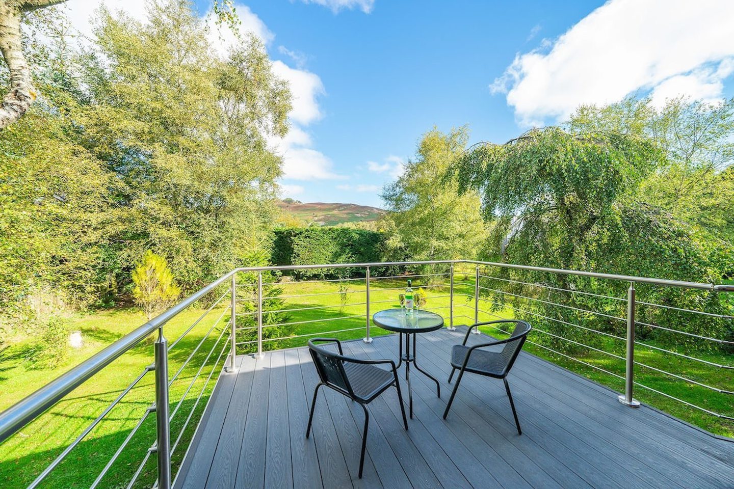 Scenic views from enclosed balcony out to the garden and the Sidlaw hills beyond.