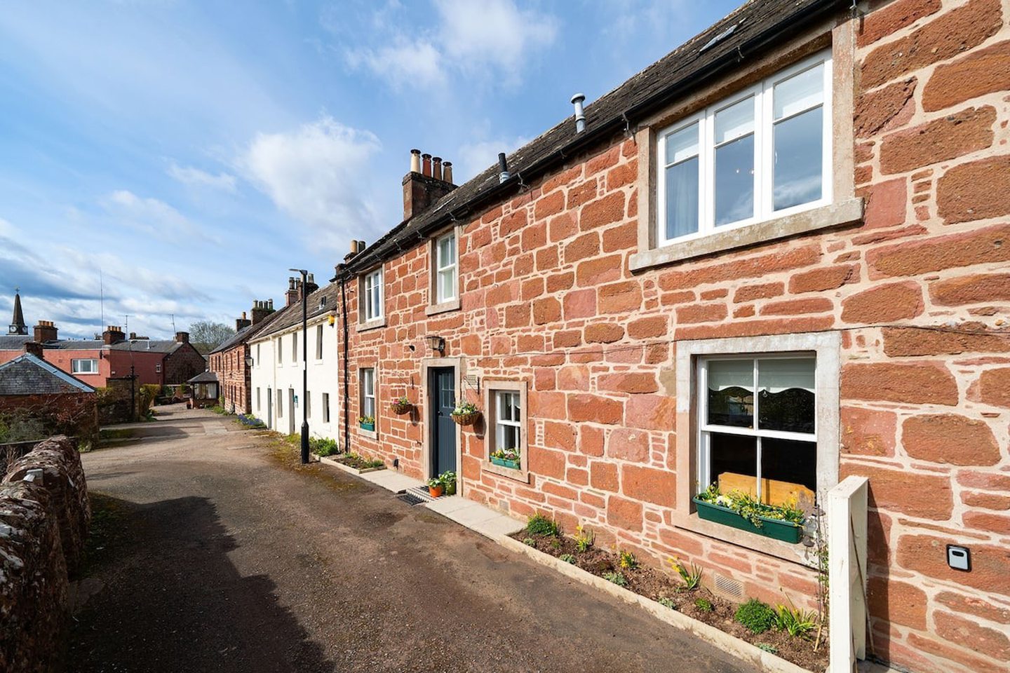 Exterior of the red-bricked Thrums Cottage in Kirriemuir.
