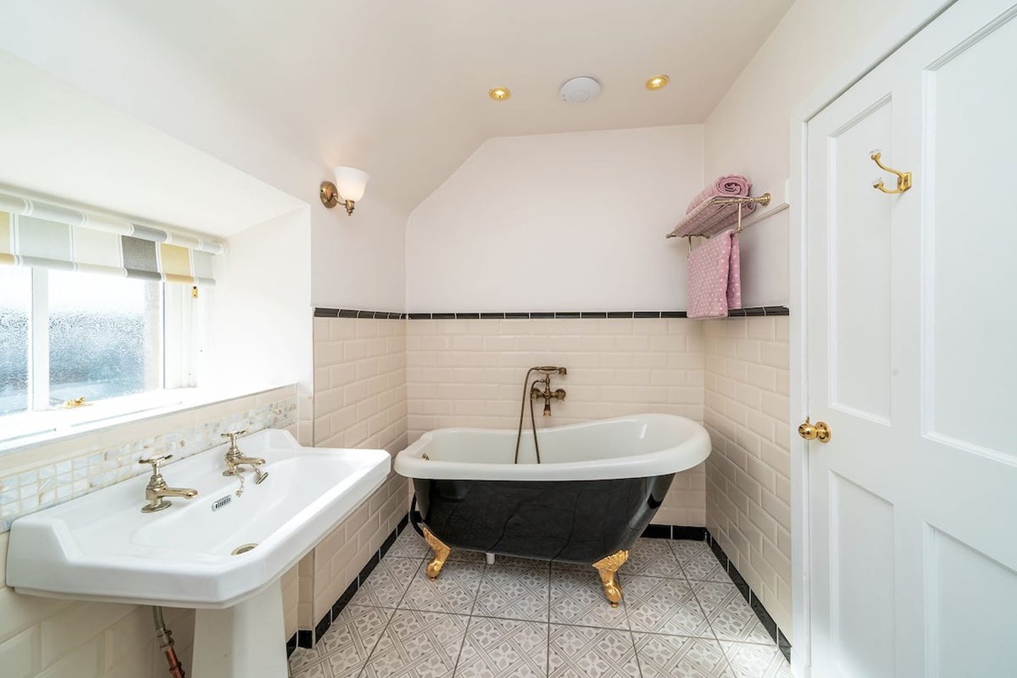 Large bathroom with claw-foot roll-top bath.