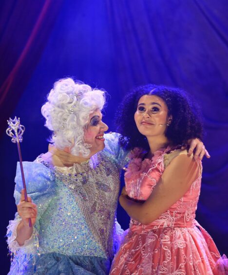 Image shows Alan Steele as Fairy Mary Doll and Tinashe Warikandwa as Cinderella on stage at The Byre Theatre in St Andrews.