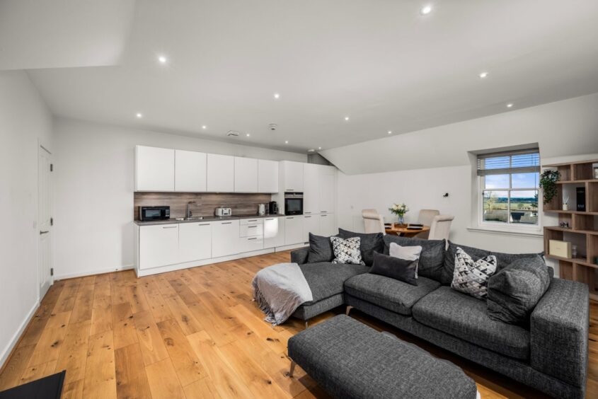 The living space features wooden flooring at Monifieth mansion apartment 