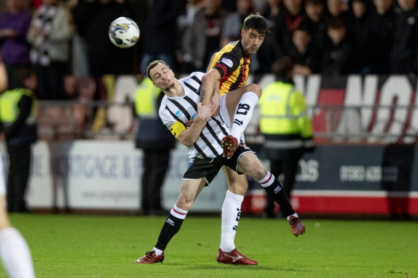 Dunfermline captain Chris Hamilton tussles for the ball with Partick Thistle striker Brian Graham. Image: Craig Brown / DAFC.