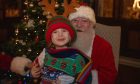 Arlo Etherington visiting Santa. Image: Marieke McBean