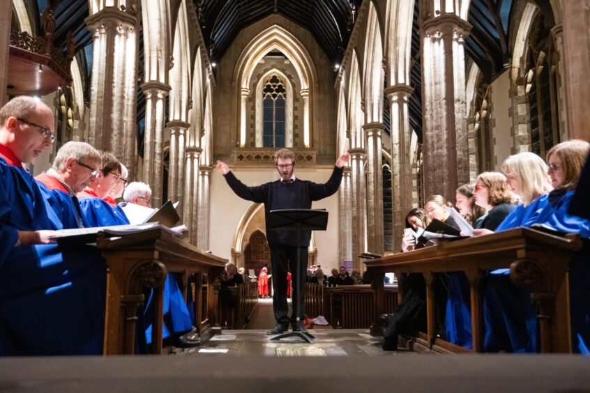 John-Luke Harris, director of music, Chaplaincy Centre, University of Dundee runs through the carols with the choir before the service at St Paul's Cathedral, Dundee. 