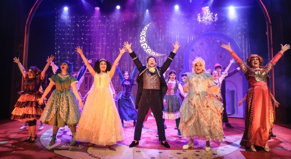 Image shows the finale of Cinderella at The Byre Theatre. Tinashe Warikandwa as Cinderella and John Boal as Buttons are centre stage. 