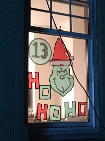 Window in the Craigie area of Perthnshowing the Grinch character, the words ho ho ho and the letter 13.