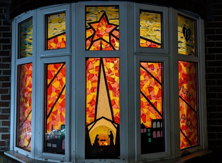 Illumniated bat window with traditional nativity and star display in the Craigie area of Perth
