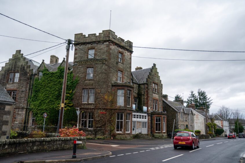 Exterior of closed Glenfarg Hotel, an imposing four-storey building with turrets and ivy covered walls.