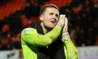 Dundee United goalkeeper Jack Walton signals that it's bedtime for daughter Lily