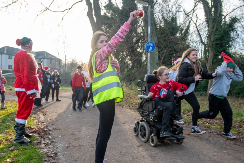 Young girl in wheelchair on Inch View primary Santa run
