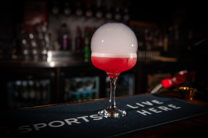 The very tempting-looking bubble that forms atop the festive Kris Kringle cocktail.