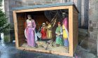 A figure of the baby Jesus has been taken after glass covering a nativity scene outside Perth's St John's Kirk was smashed open.