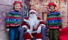 Matthew Wallace (left) and Owen Torrie with Santa Claus. Image: Craig Chalmers.