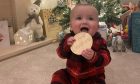 Eight-month-old Owen Anderson's first taste of Christmas in Monifieth. Image: Pamela Anderson.