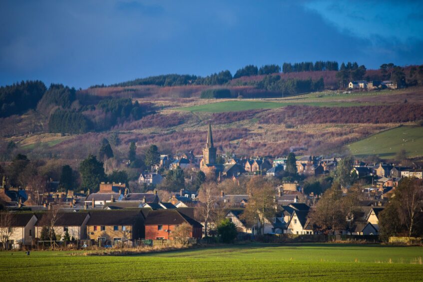 View of Alyth village surrounded by trees, hills and farmland