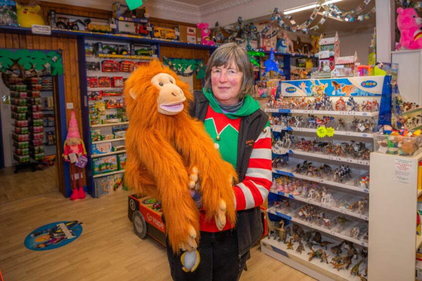 Karen Christie, owner of Fun Junction with a toy monkey