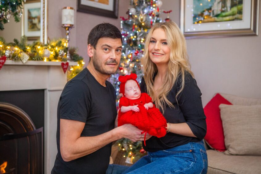 Rachael Nixon and partner Michael Jack at home for Christmas with baby daughter Daisy. 