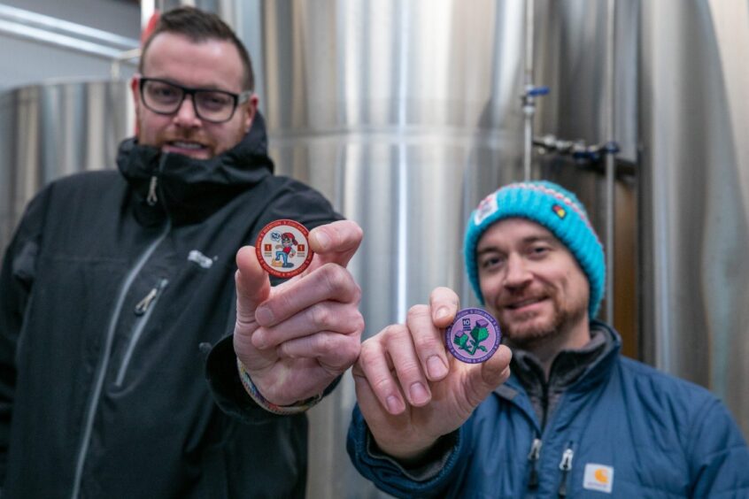 CoelBrew co-founders David and Ryan hold up their new beer coins. 