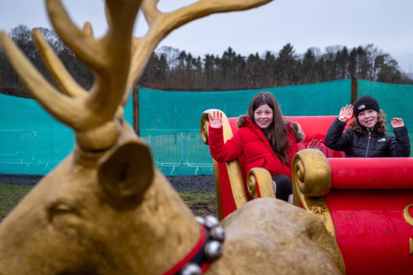 Brooke (11) and Freddie (7) from Newport in Santa's sleigh at the Scottish Deer Centre Christmas Grotto