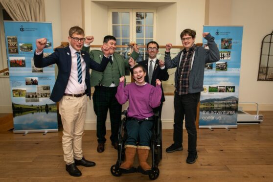 The five young people raising their arms in a victory salute at the Duke of Edinburgh's Award Perth and Kinross Association presentation.