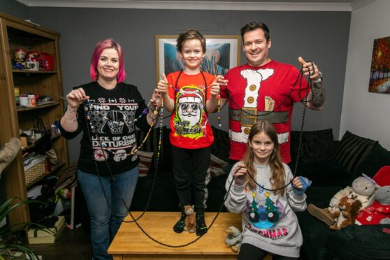 The King family from Kinross proudly holding Ezekiel's beads of courage, a trophy of him surviving cancer. Image: Steve Brown/DC Thomson