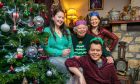 Merry Kwekmas: Nick Kwek with his dad George and sisters Caroline and Natalie by their dad's Christmas tree in Fife. Image: Steve Brown/DC Thomson.