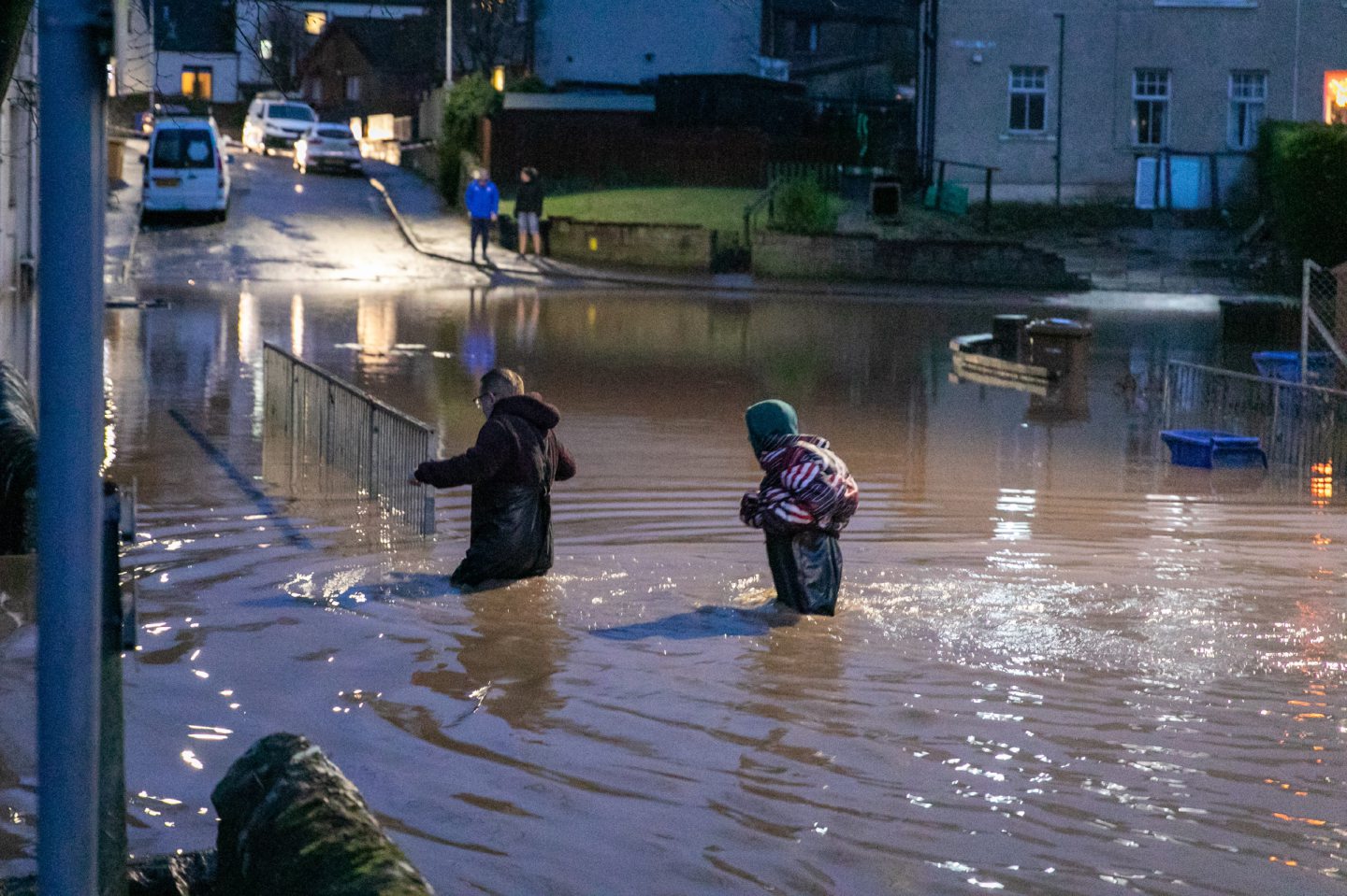 Residents wade through the water in Cupar