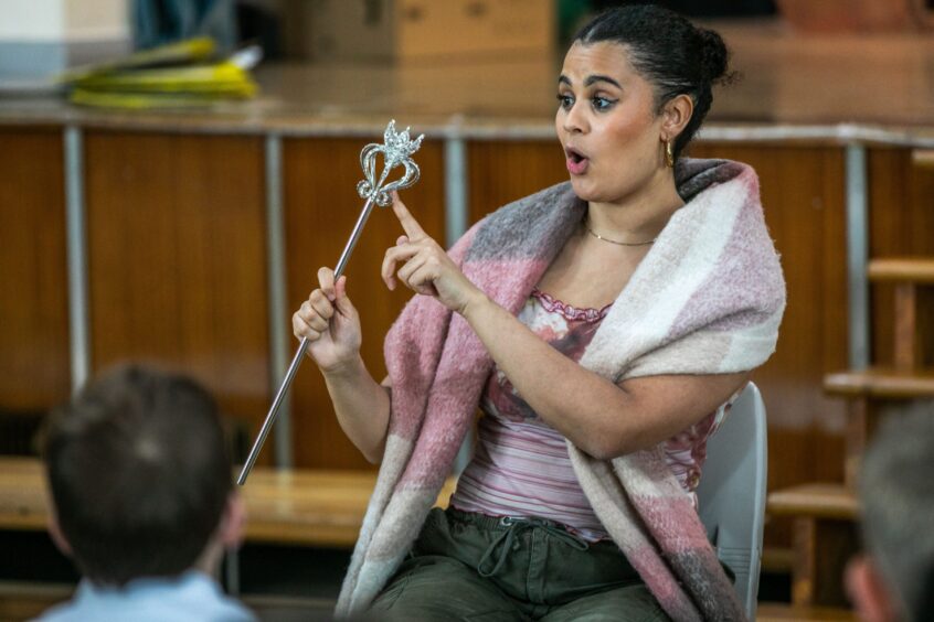 Image shows: Tinashe Warikandwa visiting her former school Greyfriars Primary in St Andrews to talk to the pupils about her role as Cinderella at The Byre Theatre in St Andrews. Tinashe is dressed casually and is holding the magic wand from the show.