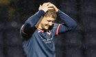 Jack Hamilton holds his hands on his head with a look of anguish on his face.