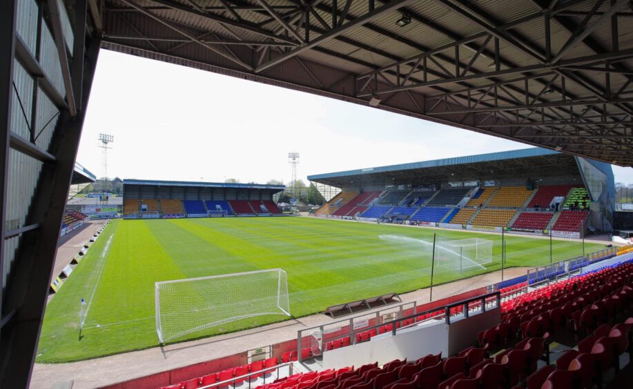 The inside of McDiarmid Park, with sprinklers watering the pitch 