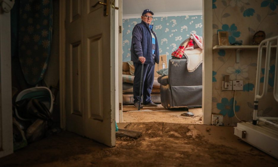 Ian Stewart in his flood-damaged home on Brechin's River Street.