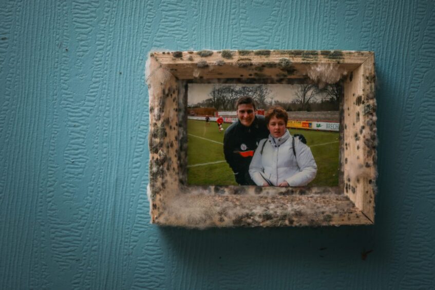 A photo of Ian Stewart's granddaughter with one of her favourite footballers - covered in mould.