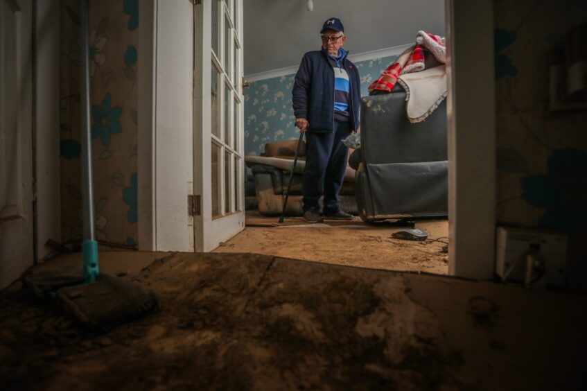 Ian Stewart surveys the damage to his property on River Street, Brechin after Storm Babet. 