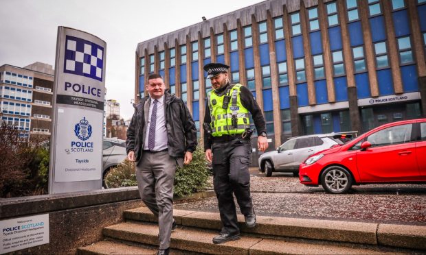 Dectective Inspector Scott Carswell leaving the Bell Street police HQ with Constable Thomas Fitzpatrick. Image: Mhairi Edwards/DC Thomson