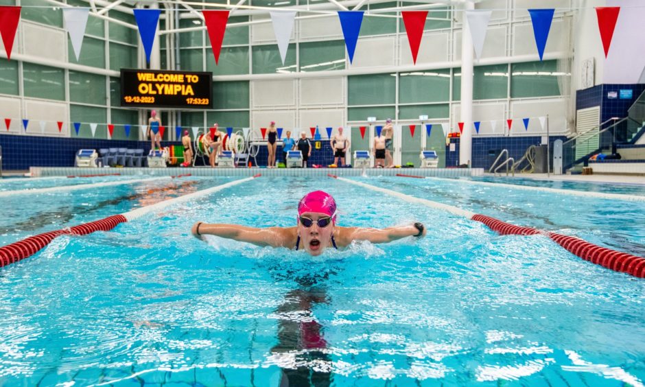 a swimmer swims inside a lane in a pool at the Dundee Olympia