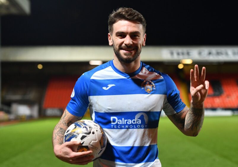 George Oakley leaves with the match ball for Morton