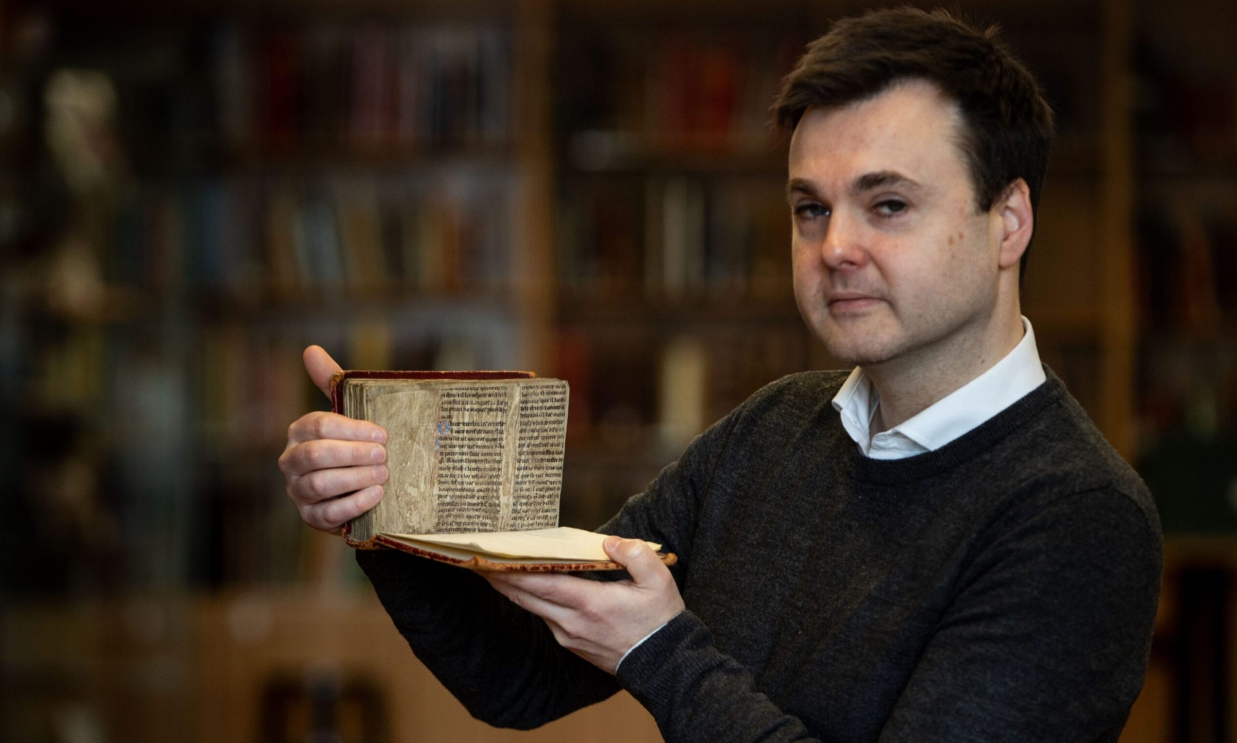 Craig Pearson from Angus Archives with the Merlin extract found at Arbroath Abbey